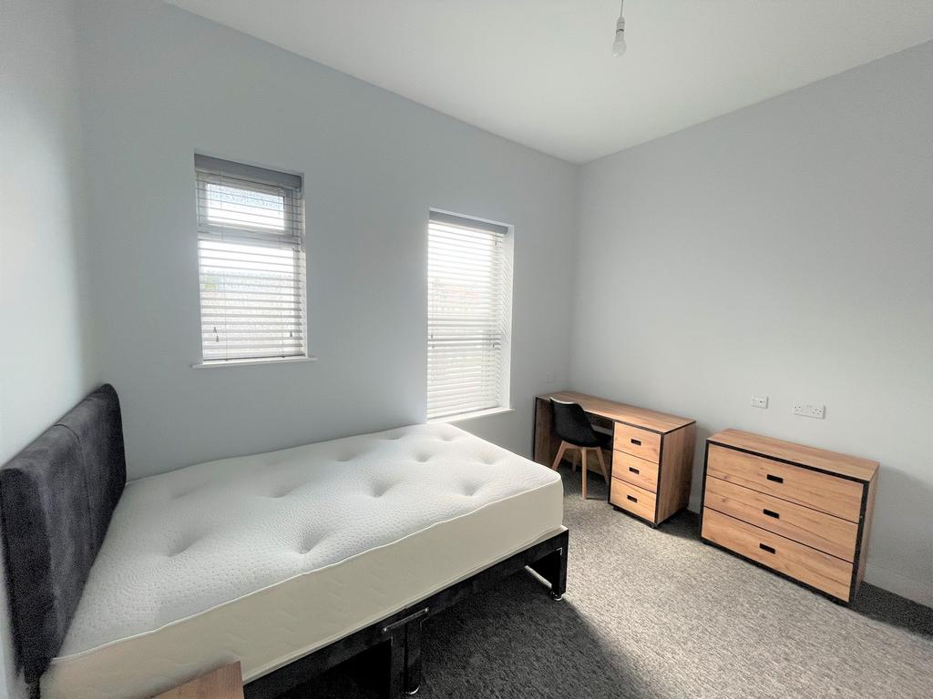 A bright and spacious double bedroom featuring ...