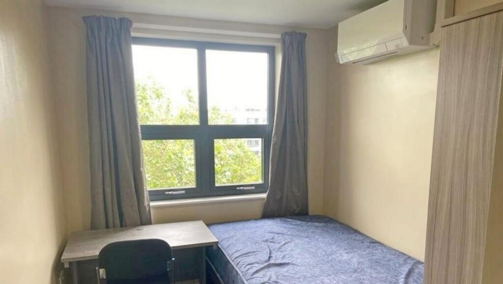 This cozy double bedroom features ample natural...