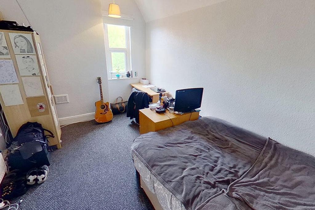 Spacious double bedroom featuring a cozy atmosp...