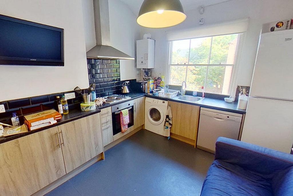 A well-equipped kitchen featuring modern applia...