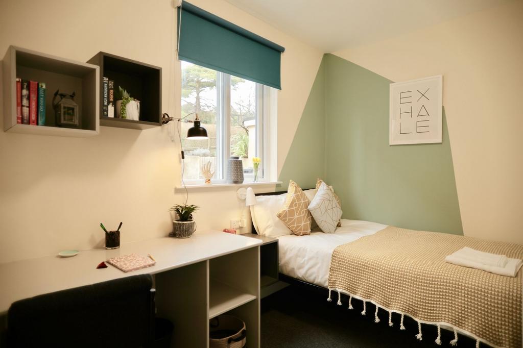 This cozy double bedroom features a comfortable...