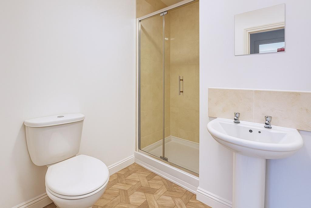 Bright, modern bathroom with a tiled shower enc...