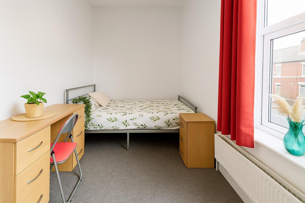 Bright, simply furnished single bedroom with a ...