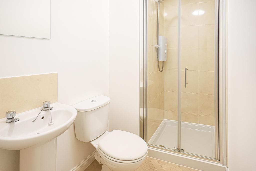 Bright, modern bathroom with a walk-in shower, ...