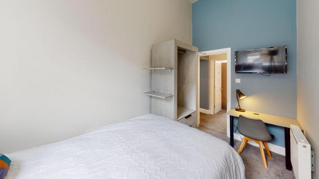 A bright and inviting double bedroom featuring ...
