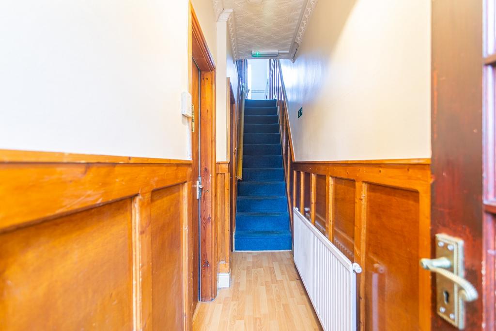Welcoming hallway featuring beautiful wood pane...