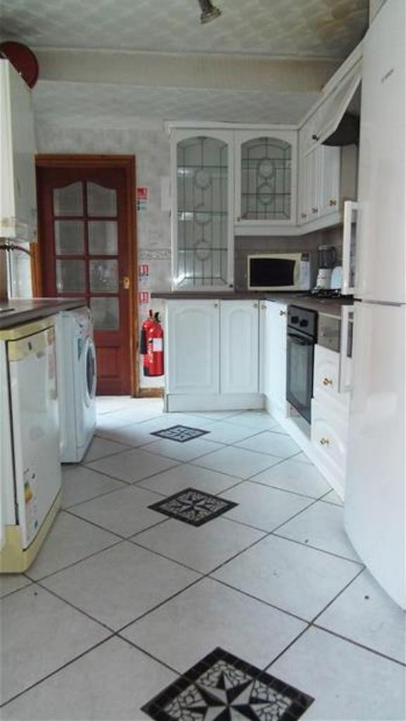 This charming kitchen features a blend of moder...