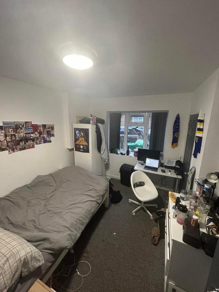 A cozy double bedroom with a workspace and ampl...