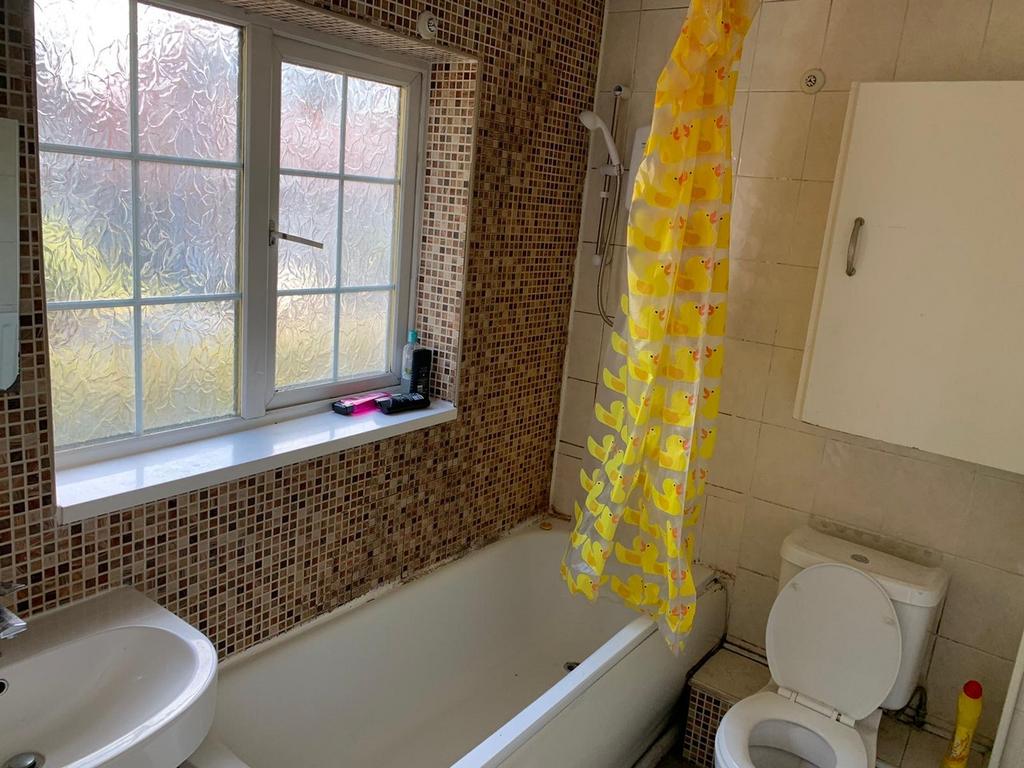 Bright and inviting bathroom featuring a spacio...