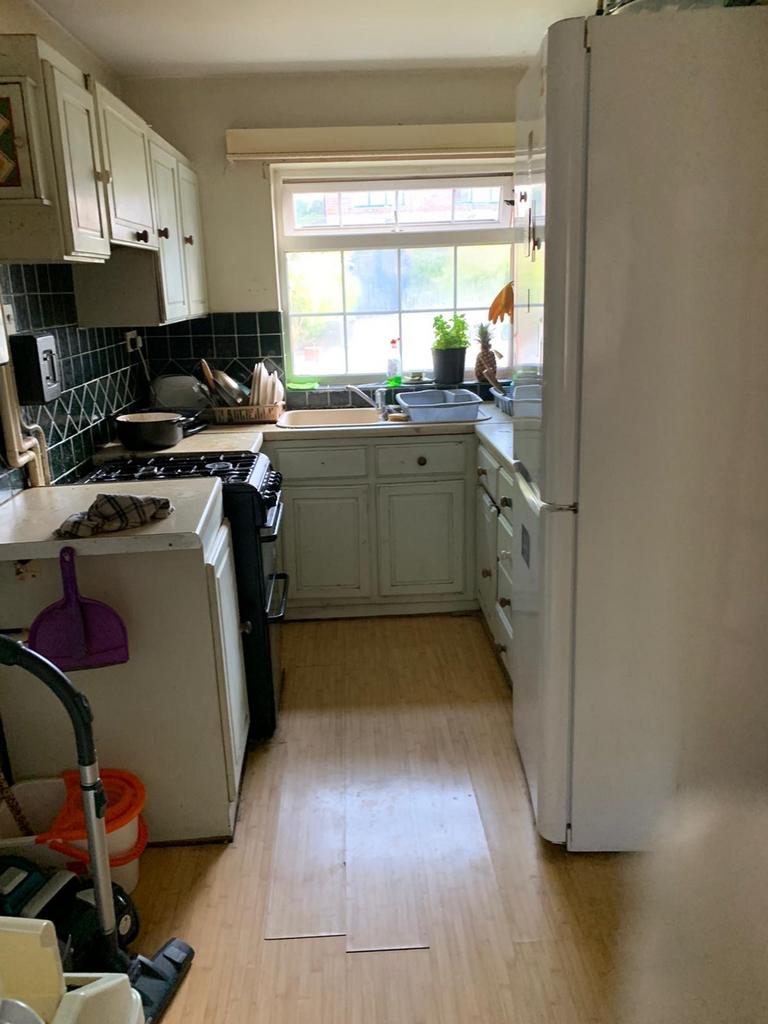 This cozy kitchen features ample cabinetry and ...