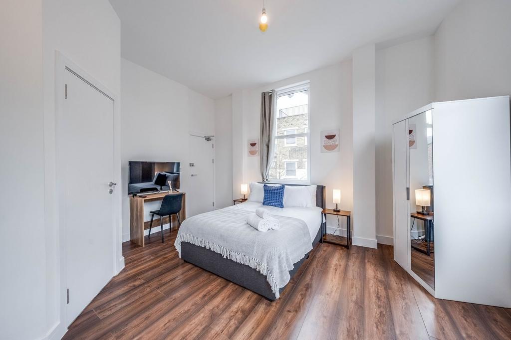 Bright and spacious master bedroom featuring a ...