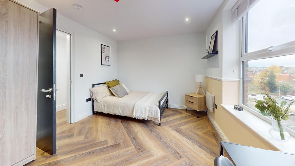 A bright and inviting double bedroom featuring ...