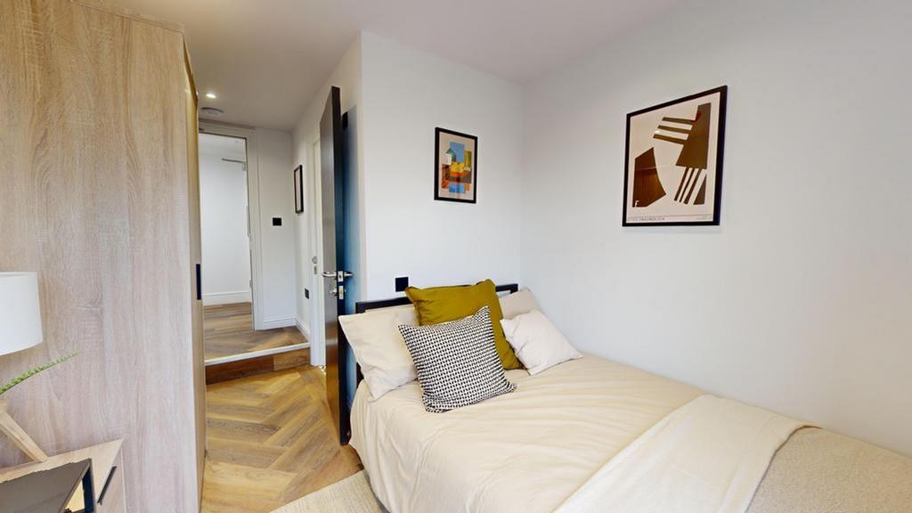 A tidy and inviting double bedroom featuring st...