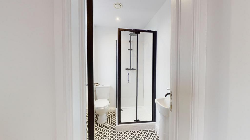 A stylish and modern bathroom featuring a spaci...