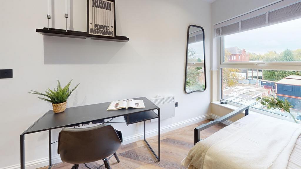 A stylish and well-lit double bedroom featuring...