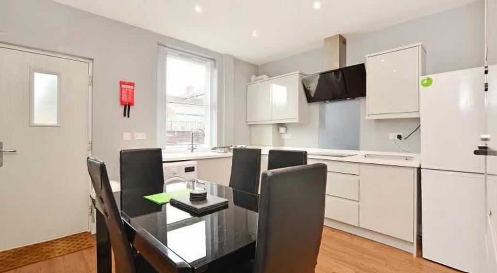 A modern kitchen featuring sleek cabinetry, a s...