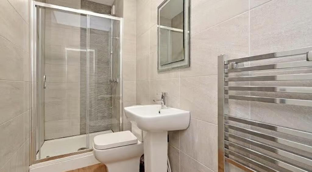 Modern bathroom suite featuring a sleek shower,...