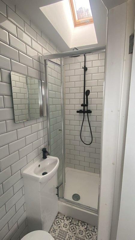 Bright and modern bathroom featuring stylish wh...