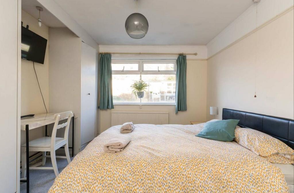 A bright and inviting double bedroom featuring ...