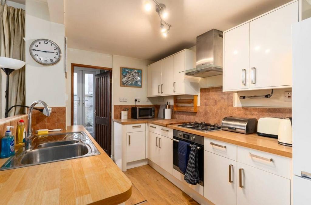 A bright and tidy kitchenette with modern appli...