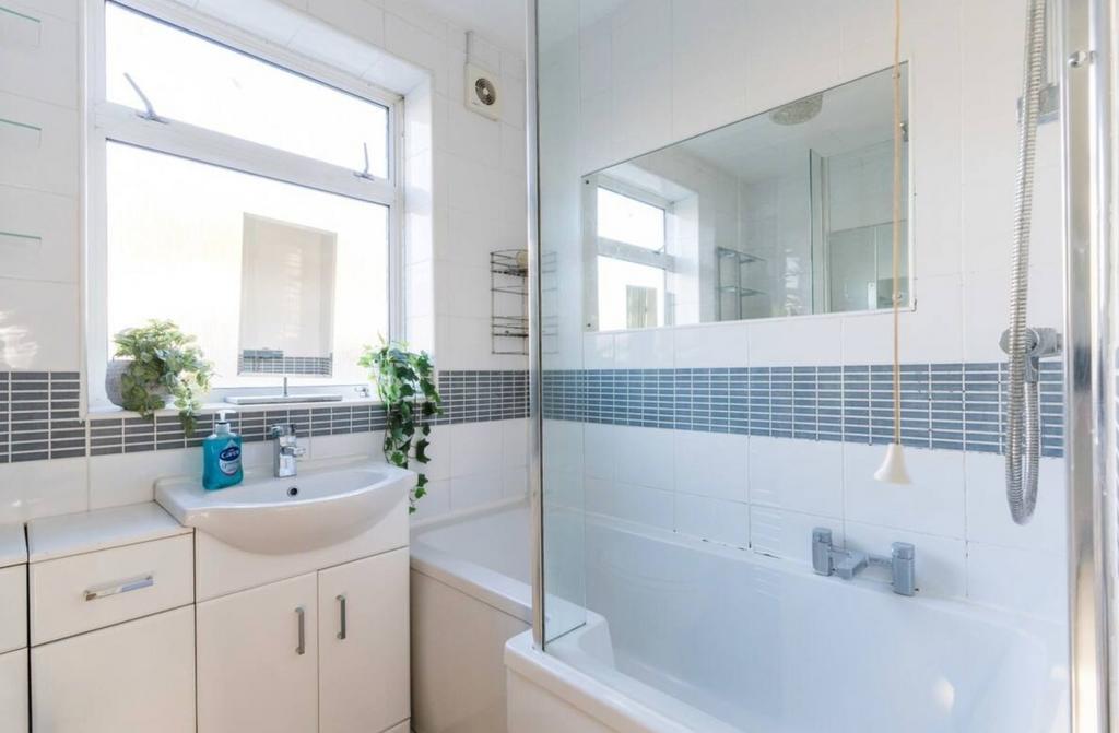 A bright and modern bathroom featuring a spacio...