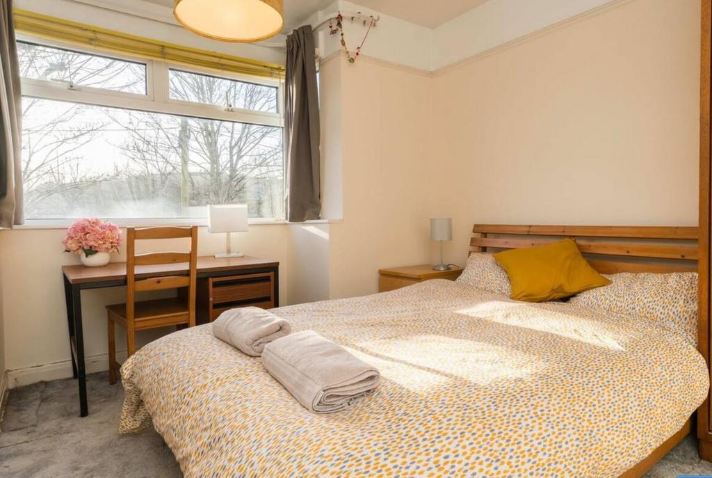 A bright and inviting double bedroom with ample...