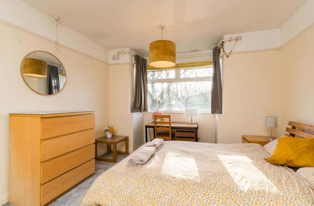 A bright and inviting double bedroom featuring ...
