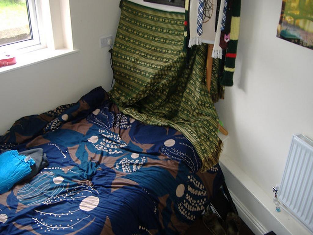 A cozy double bedroom featuring a vibrant quilt...