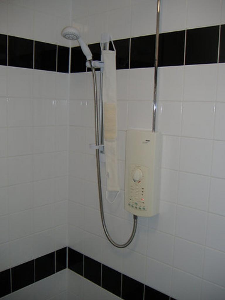 A well-maintained shower area featuring modern ...