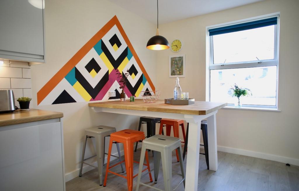 A vibrant kitchen featuring a modern design wit...