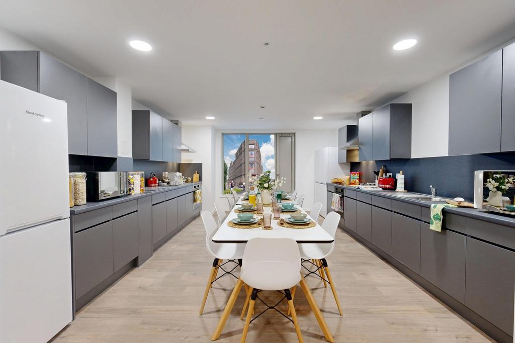This modern kitchen features sleek cabinetry an...