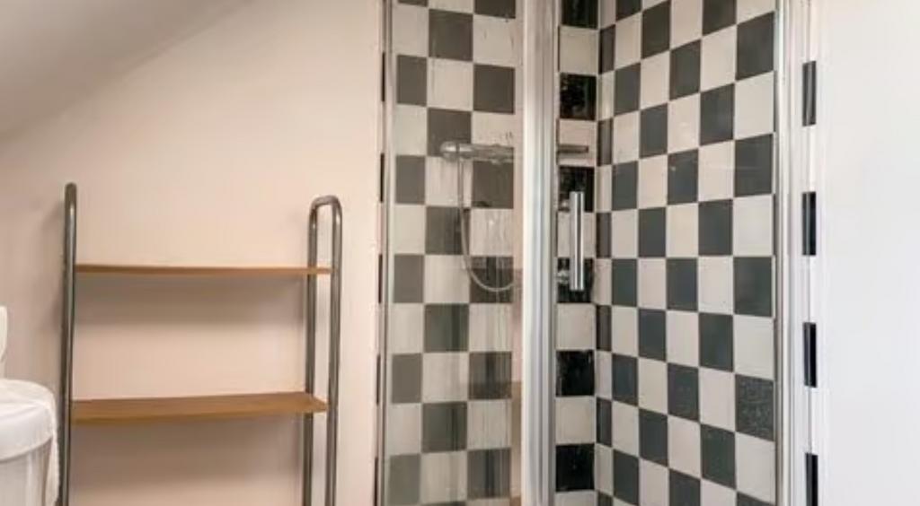 A modern bathroom featuring a stylish black and...