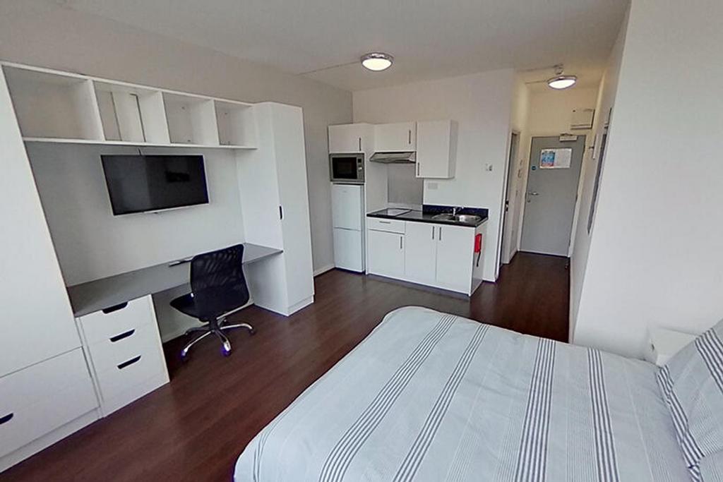 This inviting double bedroom features a comfort...