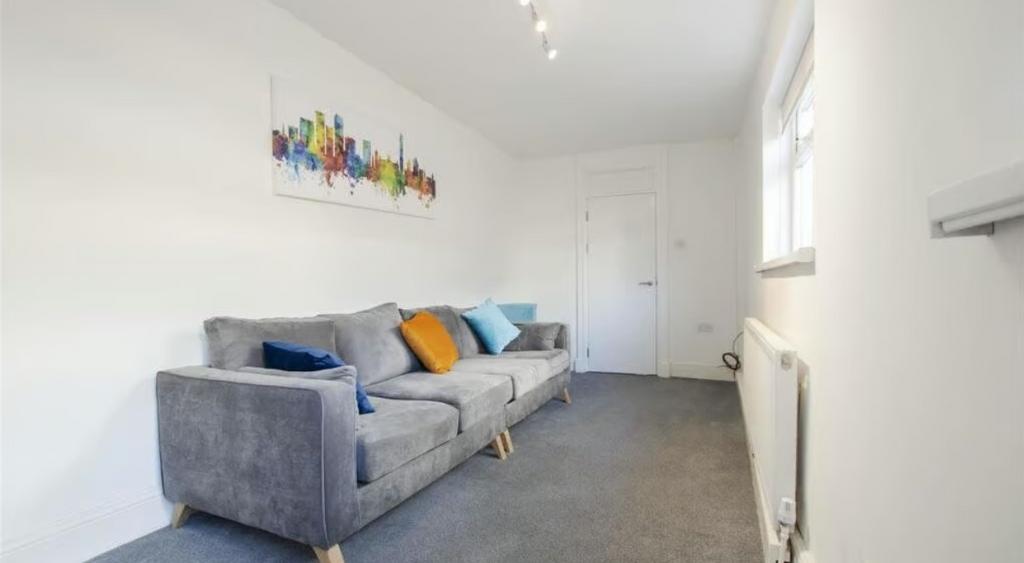 A neat and modern living room featuring a comfo...