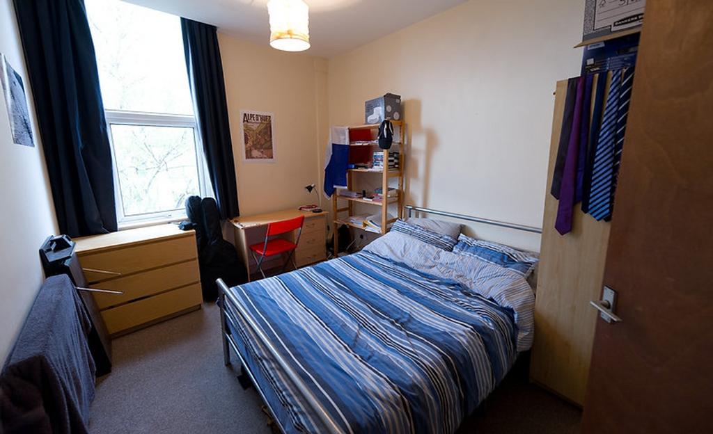 This cozy double bedroom features a comfortable...