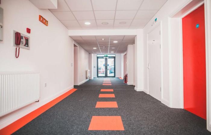 Bright and modern hallway featuring clean white...