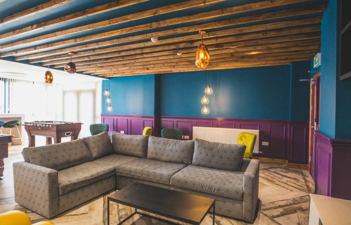 A stylish communal lounge featuring a spacious ...