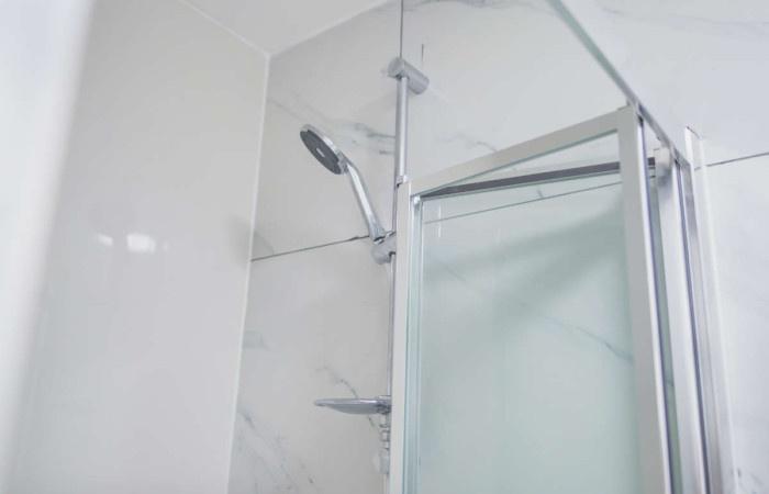 Modern bathroom shower area with a sleek overhe...