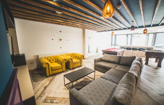 A stylish communal lounge featuring comfortable...