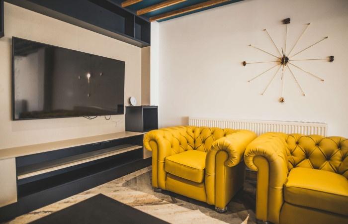 A stylish living room featuring bold yellow arm...