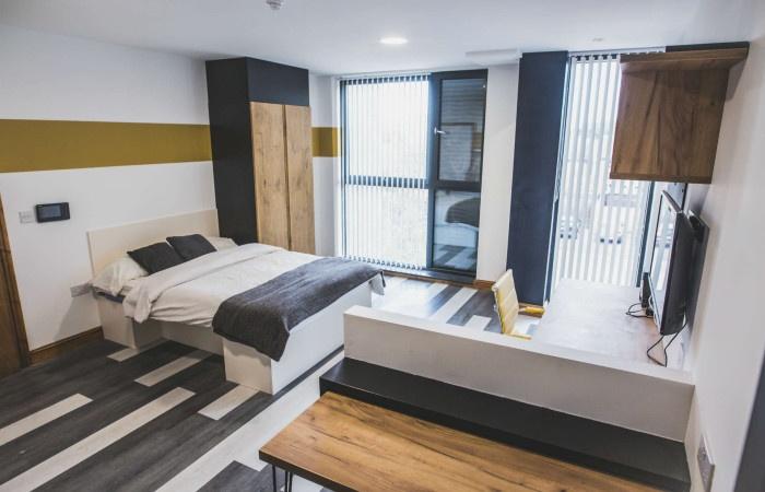 A modern and spacious master bedroom featuring ...