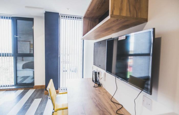 A modern communal workspace featuring large ver...