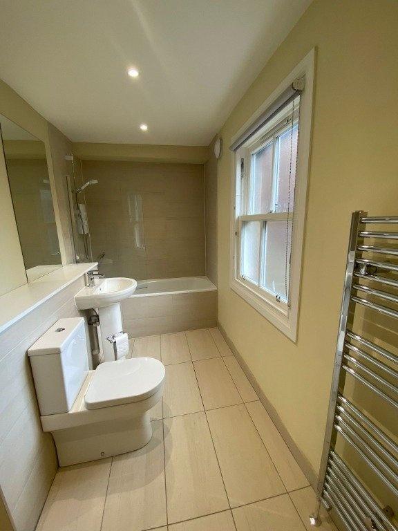 A clean and modern bathroom suite featuring a f...