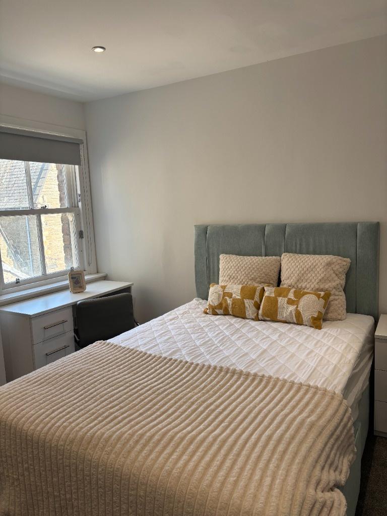 Bright and cozy double bedroom featuring a comf...
