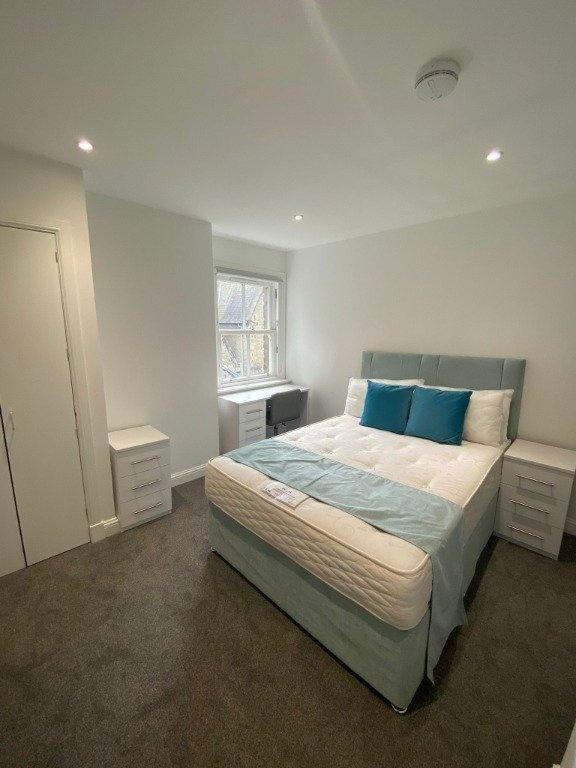 A bright and neat double bedroom featuring a co...