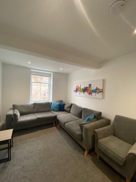 A cozy living room featuring a comfortable L-sh...