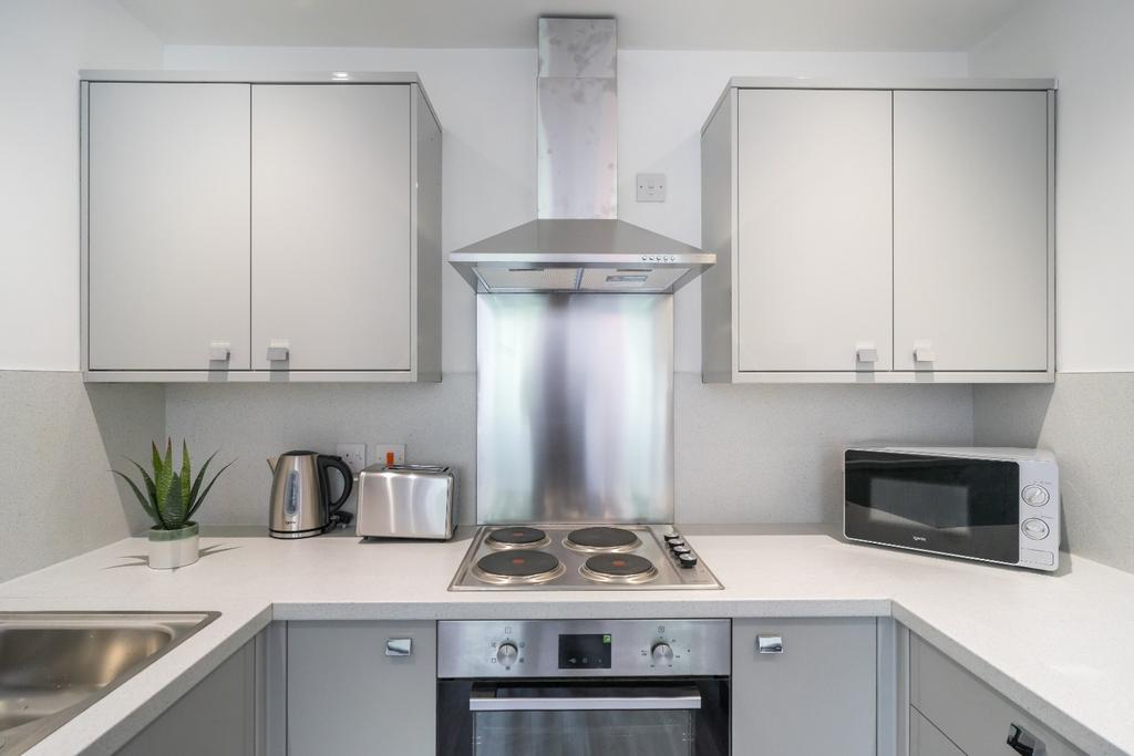 A modern kitchen featuring sleek cabinetry, sta...