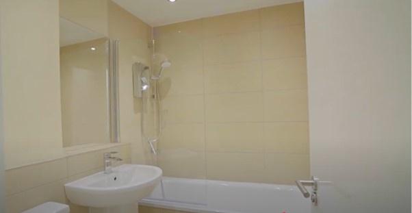 A modern and clean bathroom suite featuring a w...