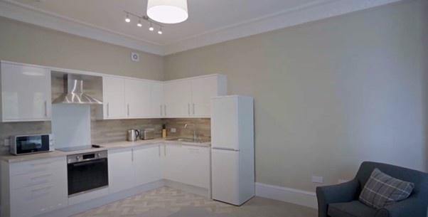 Bright and modern kitchen area featuring sleek ...