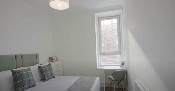 Bright and neat double bedroom featuring a comf...